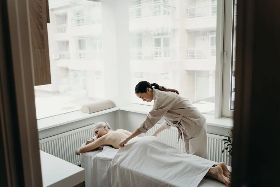 A relaxing spa day with a woman receiving a massage from a therapist indoors.
